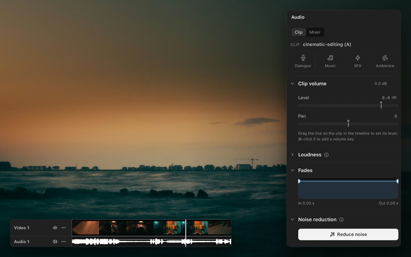 The sea at dusk, with the audio panel beside it (clip volume, fades, noise reduction) and the audio track below.